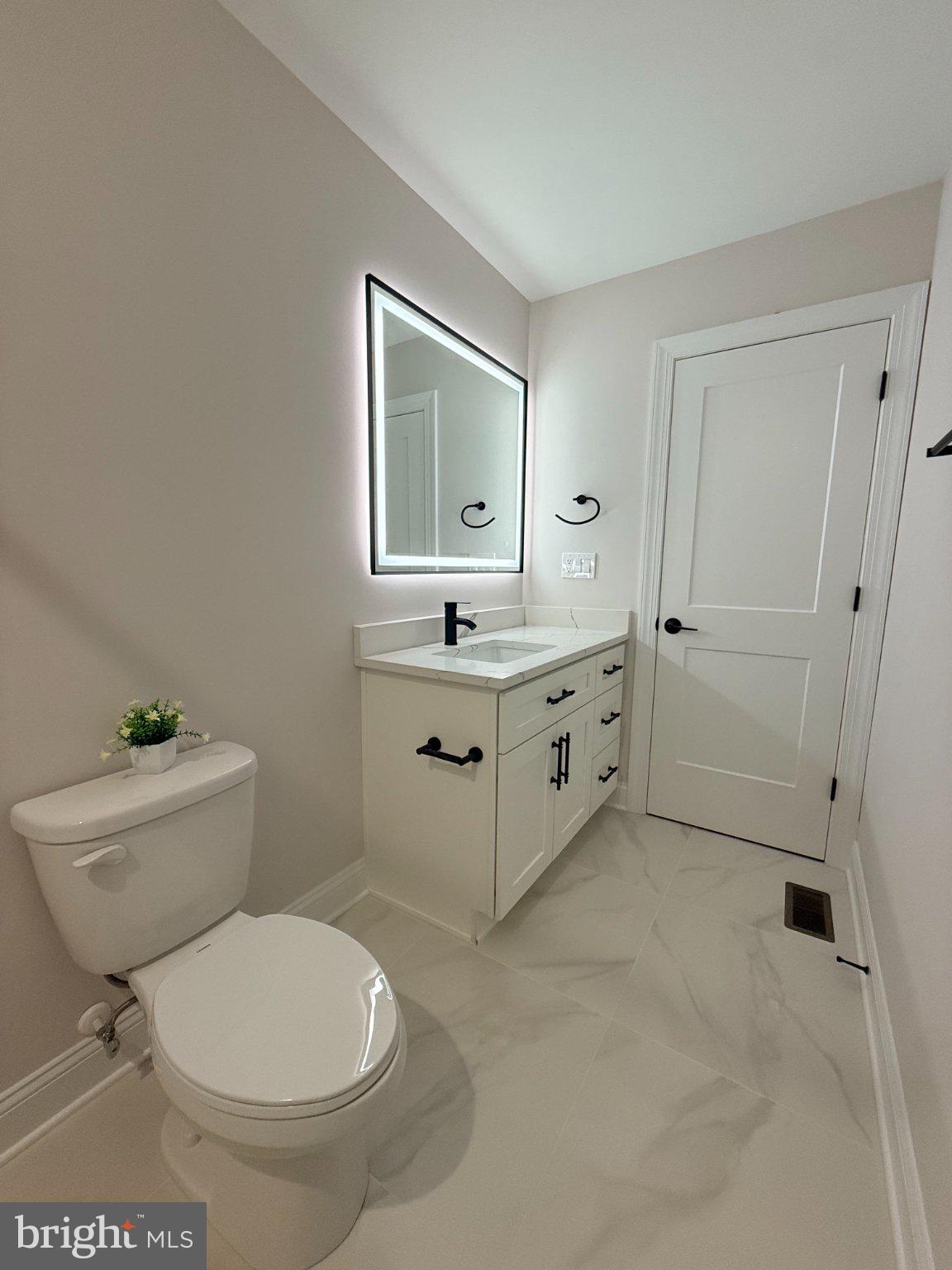 206 Saylers Creek Road Locust Grove, VA 22508 - Photo 42 of 49 a bathroom with a toilet sink and mirror