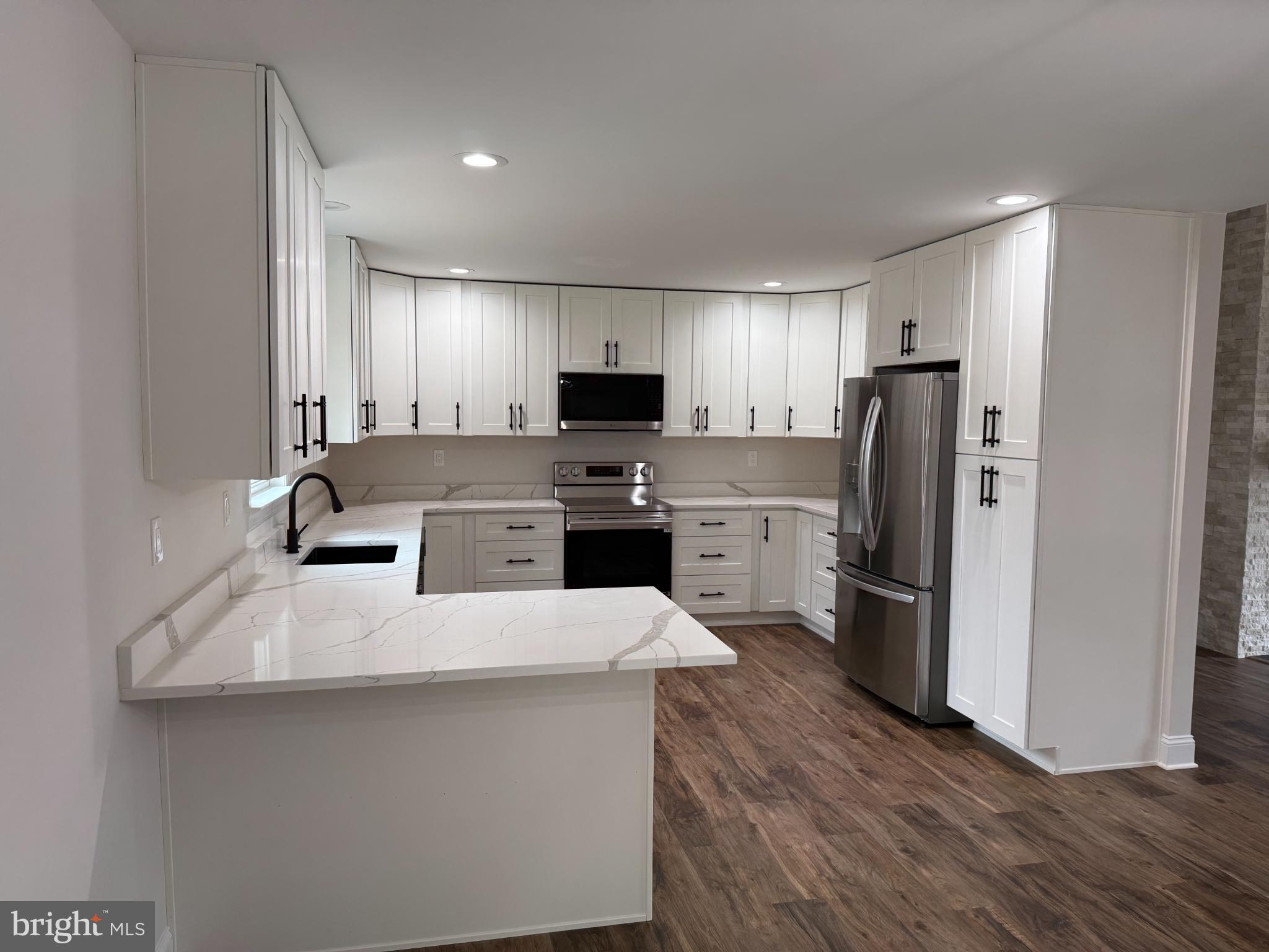 206 Saylers Creek Road Locust Grove, VA 22508 - Photo 5 of 42 a large kitchen with a center island stainless steel appliances cabinets and a couch