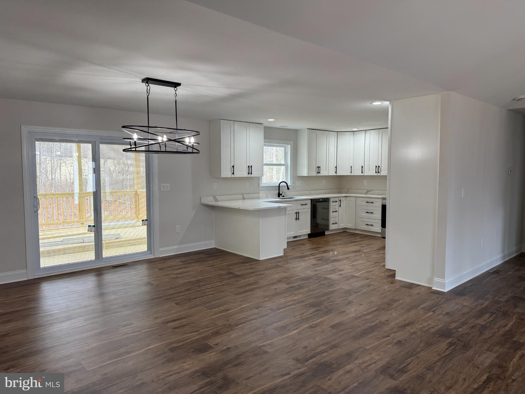 206 Saylers Creek Road Locust Grove, VA 22508 - Photo 6 of 42 a view of a kitchen with wooden floor a sink and windows