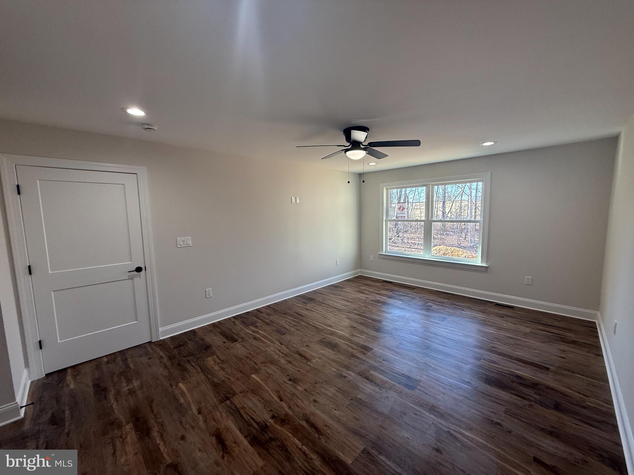 206 Saylers Creek Road Locust Grove, VA 22508 - Photo 9 of 42 a view of an empty room with a window and wooden floor