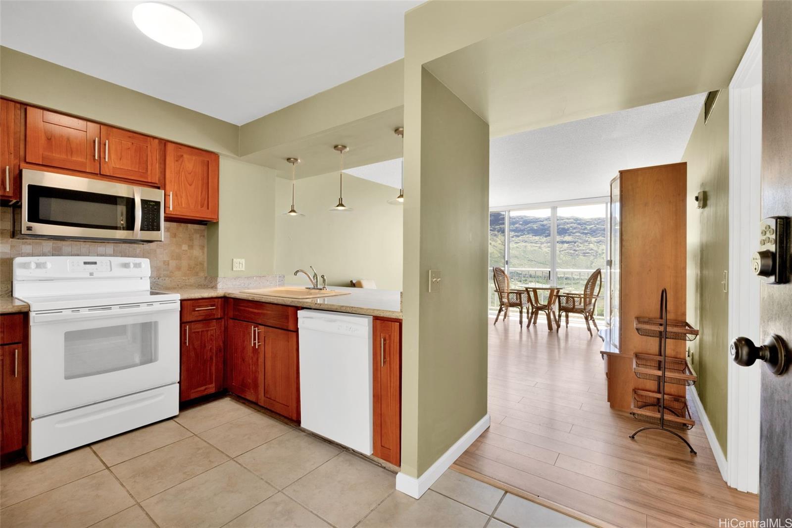 a kitchen with stainless steel appliances kitchen island granite countertop a stove a sink and a microwave