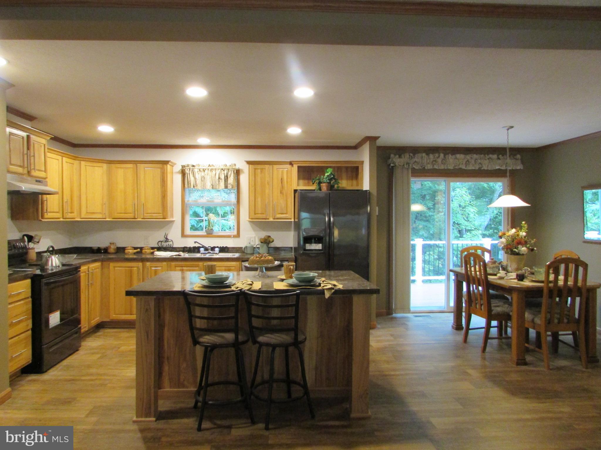 107 View Street Bellefonte, PA 16823 - Photo 11 of 42 a kitchen with stainless steel appliances granite countertop table chairs stove and refrigerator