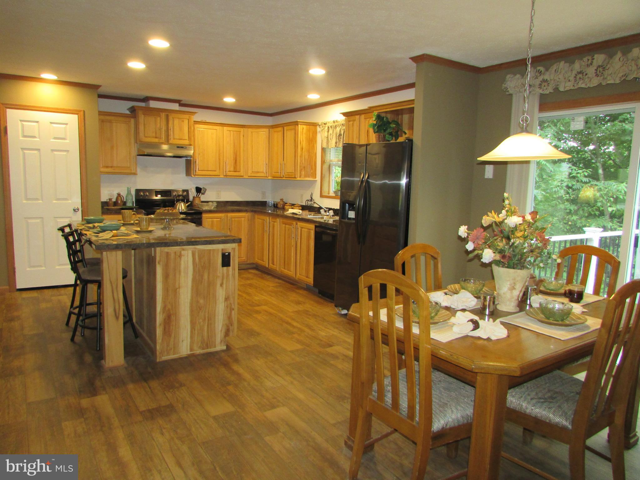 107 View Street Bellefonte, PA 16823 - Photo 13 of 42 a kitchen with stainless steel appliances kitchen island granite countertop a table chairs and a refrigerator