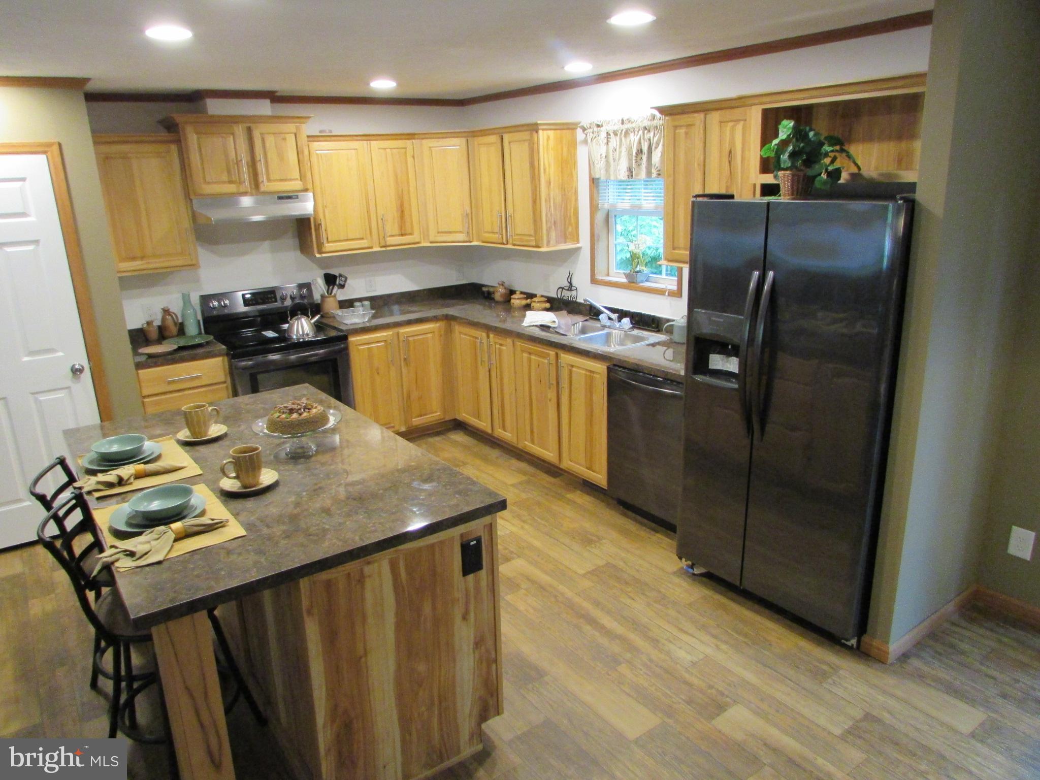107 View Street Bellefonte, PA 16823 - Photo 16 of 42 a kitchen with a refrigerator a stove a sink dishwasher with a dining table and chairs