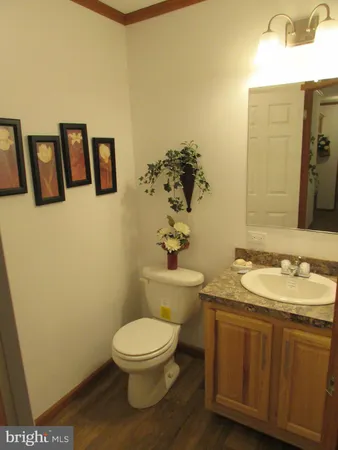 a bathroom with a toilet sink and mirror