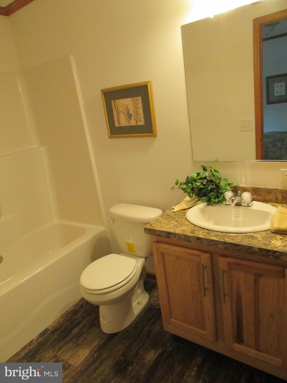 107 View Street Bellefonte, PA 16823 - Photo 30 of 42 a bathroom with a granite countertop sink toilet and a mirror
