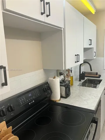 a kitchen with a stove and a sink