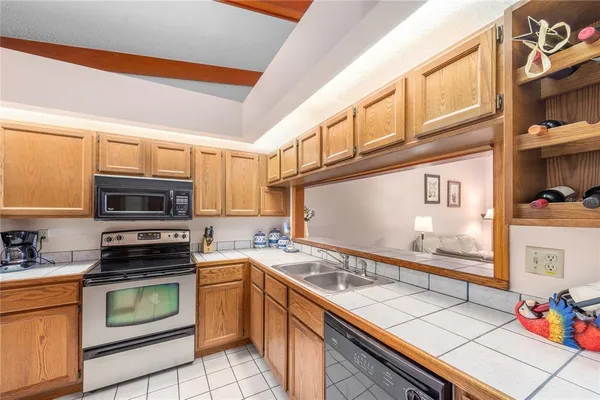 a kitchen with stainless steel appliances a stove microwave and cabinets