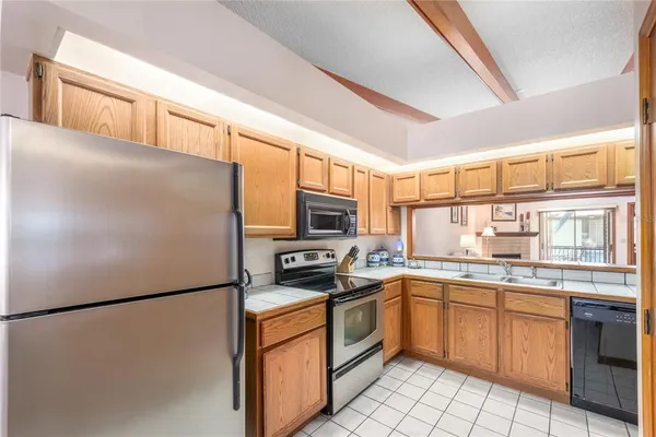 a kitchen with a refrigerator a sink and a stove