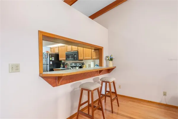 a view of a room with wooden floor and a window