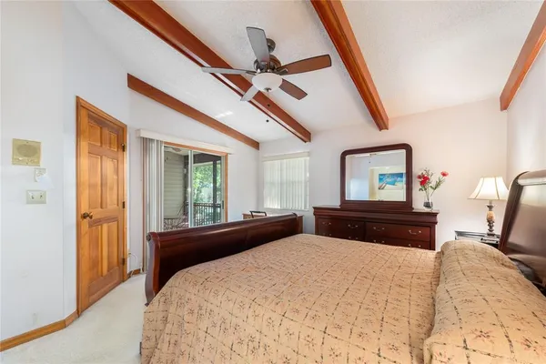 a bedroom with a bed and a large mirror