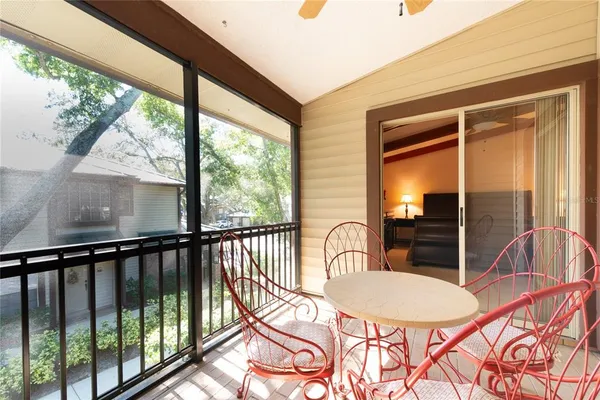a view of a balcony and dining room