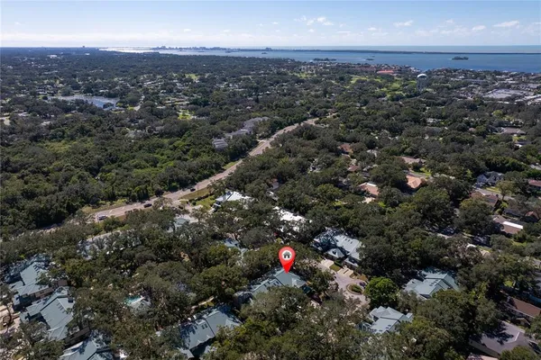 an aerial view of house with yard and mountain view in back