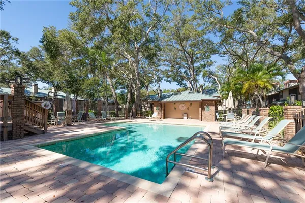 a view of a house with backyard and sitting area