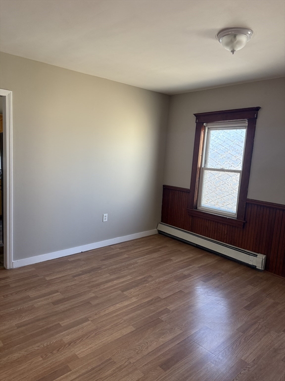 21 St George Avenue, Unit 3 Norwood, MA 02062 - Photo 2 of 5 an empty room with wooden floor and windows