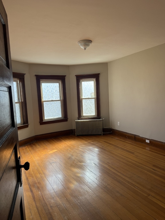 21 St George Avenue, Unit 3 Norwood, MA 02062 - Photo 4 of 5 an empty room with wooden floor and windows