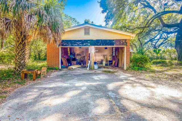 a view of a kitchen with stainless steel appliances granite countertop cabinets and a window