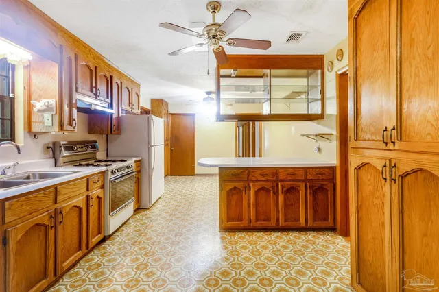 a view of a hallway with wooden floor and cabinet