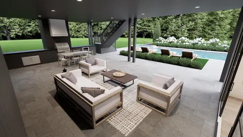a view of a patio with couches table and chairs with plants and a yard