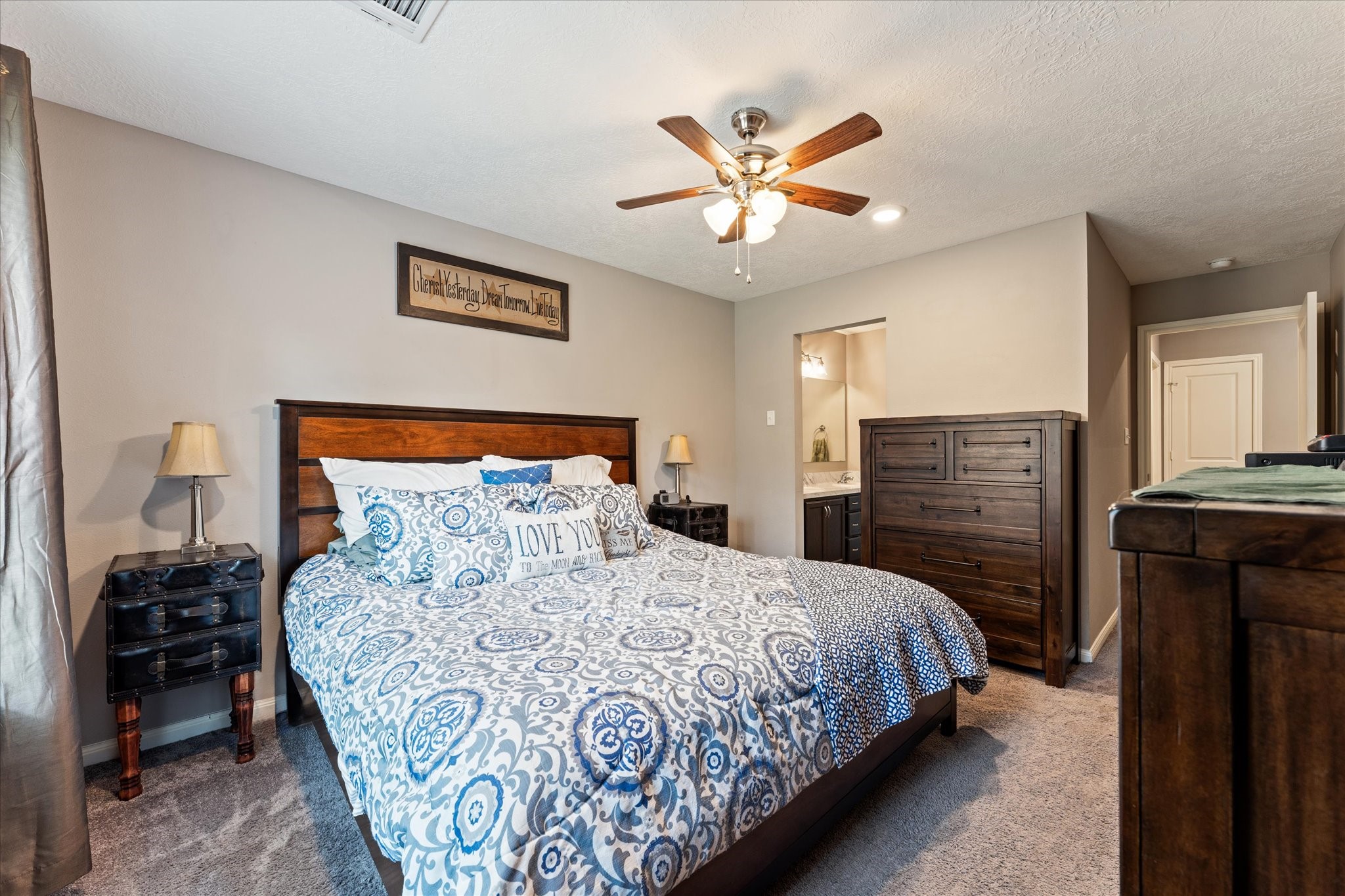 3998 Frontier Road Willis, TX 77378 - Photo 11 of 33 a bedroom with a bed and a chandelier