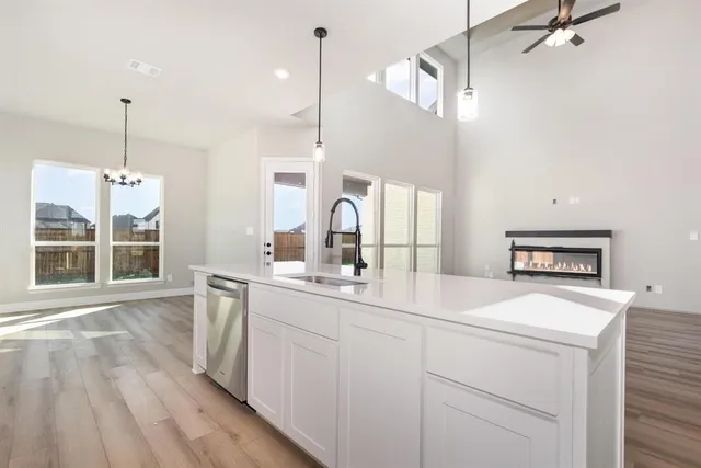 a kitchen with a sink a window and stainless steel appliances