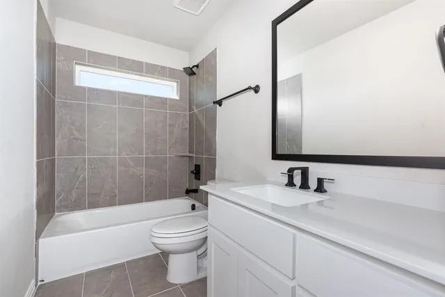 a bathroom with a toilet a sink and bathtub