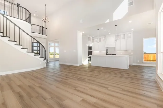 a view of a room with wooden floor and staircase