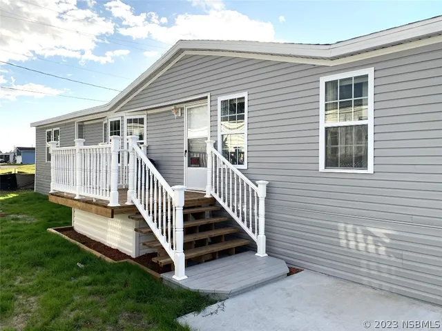 a view of a house with a yard and deck