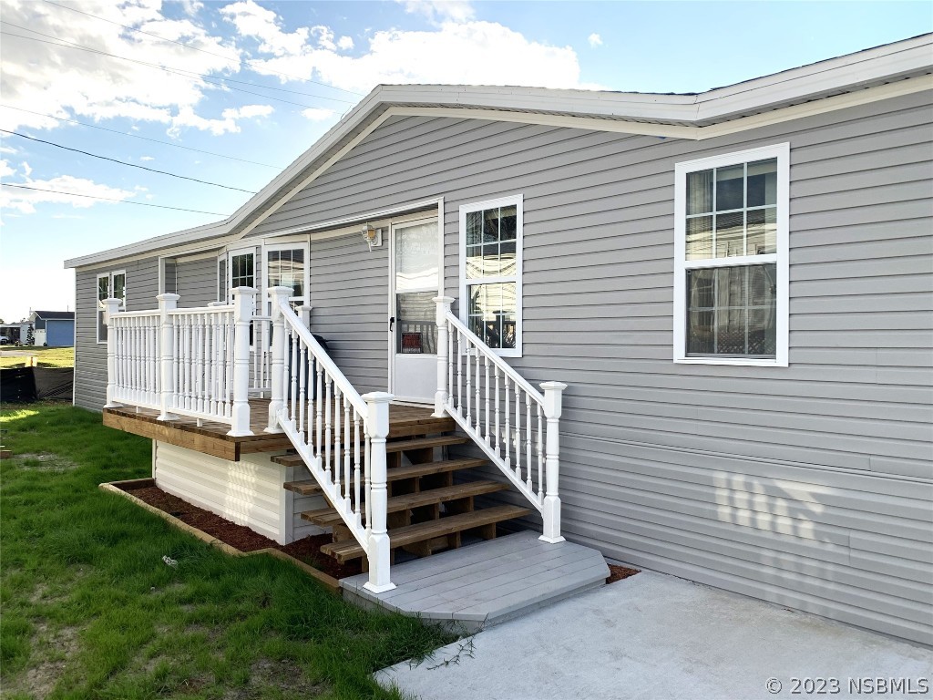 a view of a house with a yard and deck