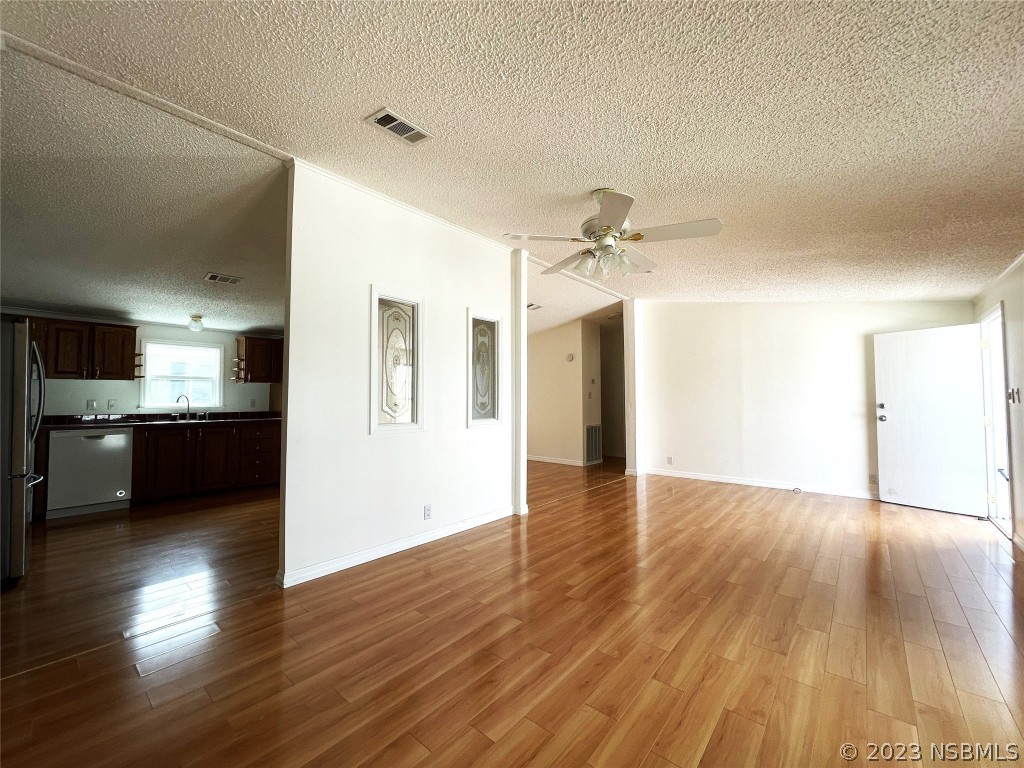 4391 Maple Avenue Edgewater, FL 32141 - Photo 15 of 50 a view of an empty room and kitchen with wooden floor
