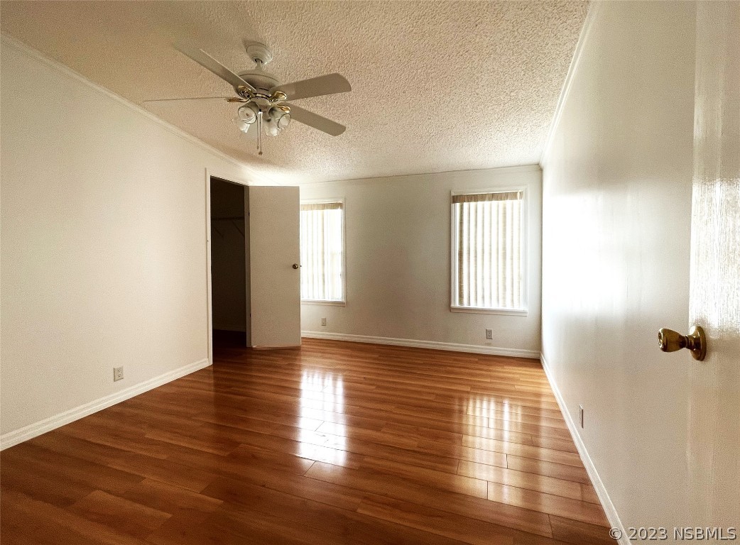 4391 Maple Avenue Edgewater, FL 32141 - Photo 16 of 50 an empty room with wooden floor fan and windows