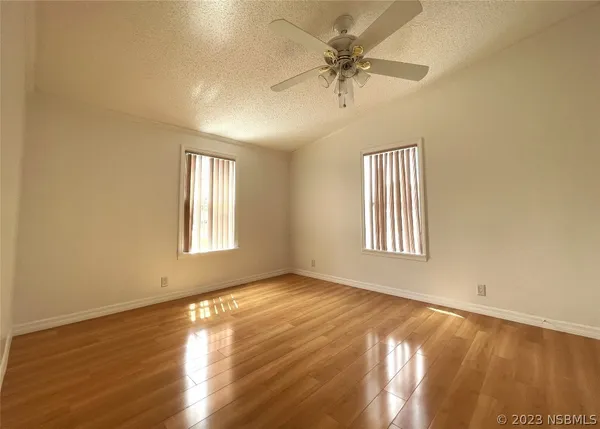 a view of a room with wooden floor