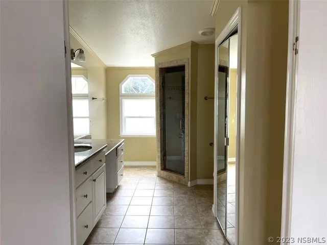 a spacious bathroom with a granite countertop sink mirror and