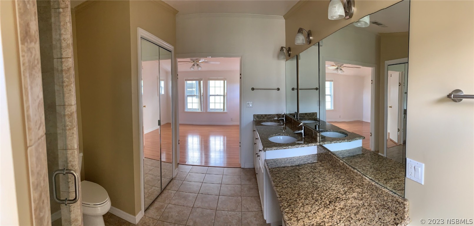 4391 Maple Avenue Edgewater, FL 32141 - Photo 34 of 50 a bathroom with a granite countertop sink a toilet a mirror and shower