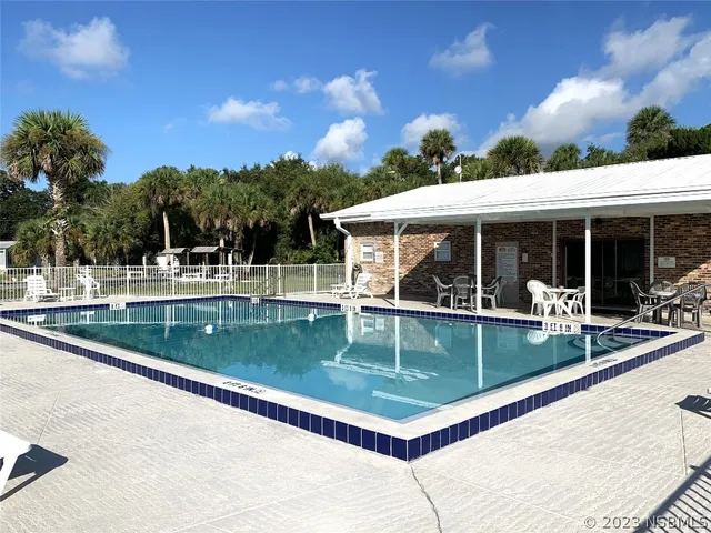 a view of a house with backyard porch and sitting area