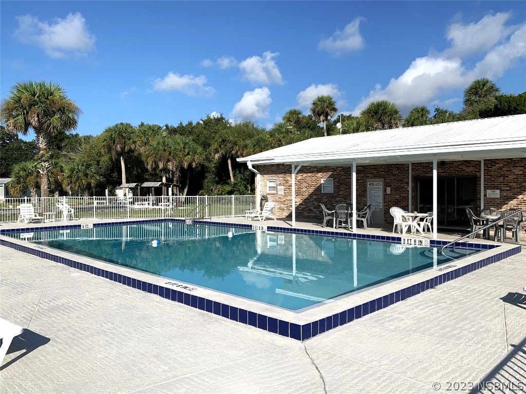 4391 Maple Avenue Edgewater, FL 32141 - Photo 37 of 50 a view of a swimming pool with a patio