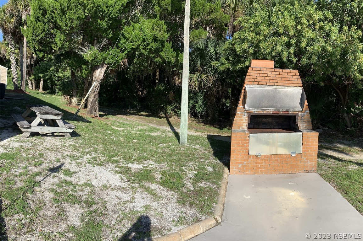 4391 Maple Avenue Edgewater, FL 32141 - Photo 44 of 50 a picture of table and chairs in the patio