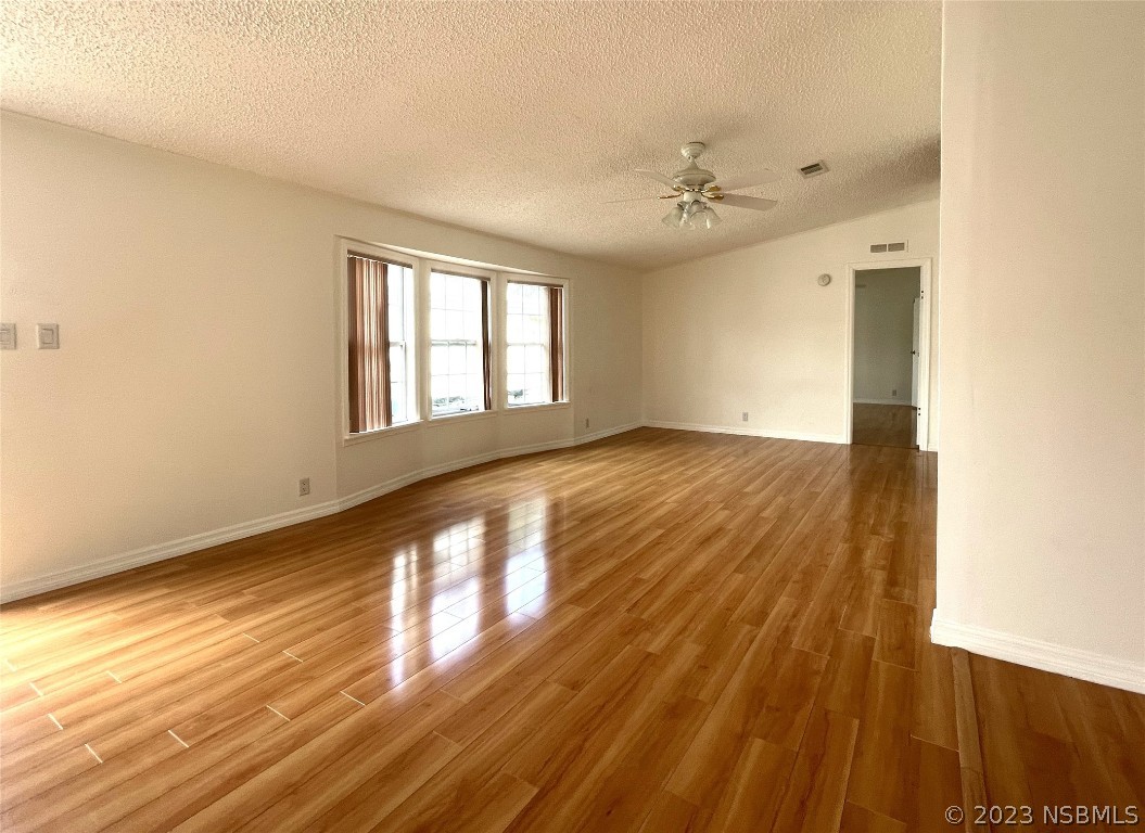 4391 Maple Avenue Edgewater, FL 32141 - Photo 5 of 50 wooden floor in an empty room with a window
