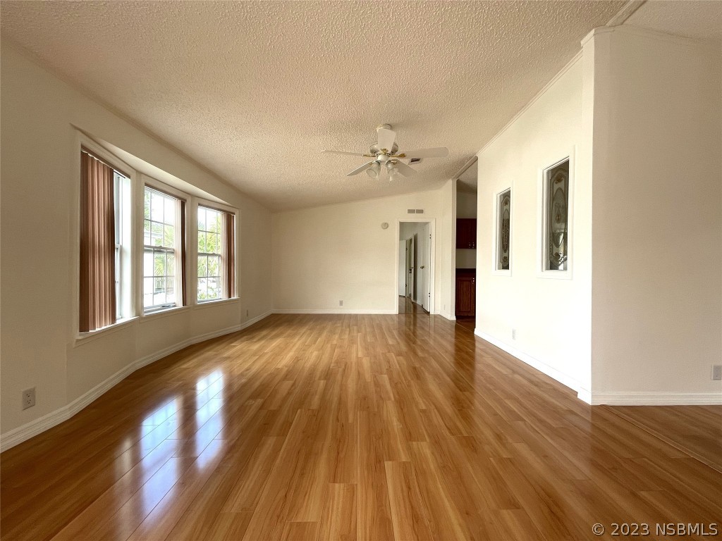 4391 Maple Avenue Edgewater, FL 32141 - Photo 6 of 50 a view of an empty room with wooden floor and a window