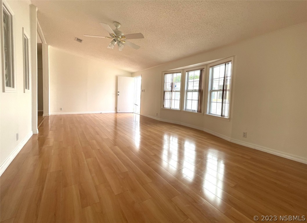 4391 Maple Avenue Edgewater, FL 32141 - Photo 8 of 50 a view of an empty room with a window and wooden floor