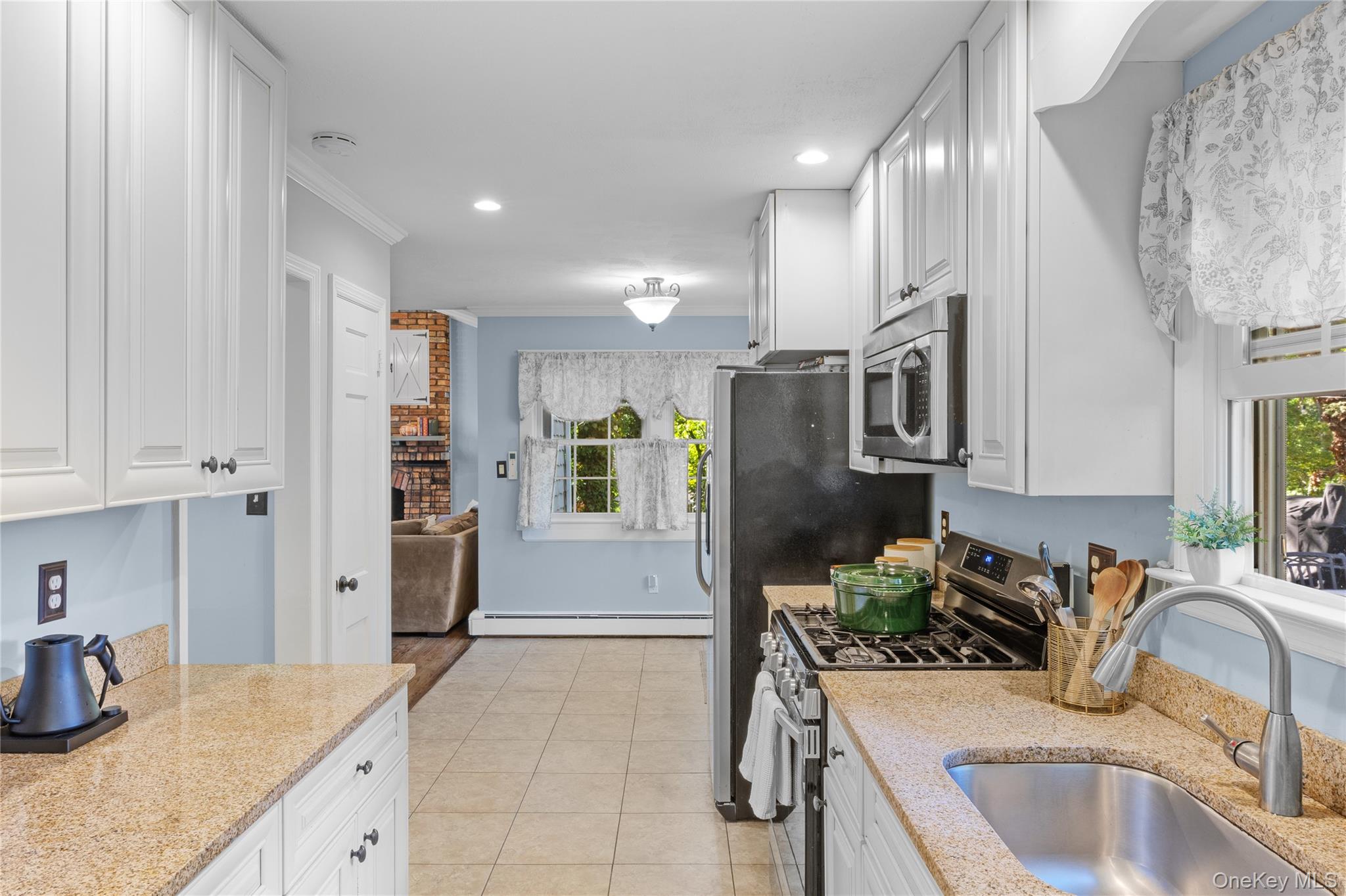 7 Shaker Hollow Road Setauket, NY 11733 - Photo 13 of 38 a kitchen with stainless steel appliances granite countertop a sink refrigerator and cabinets