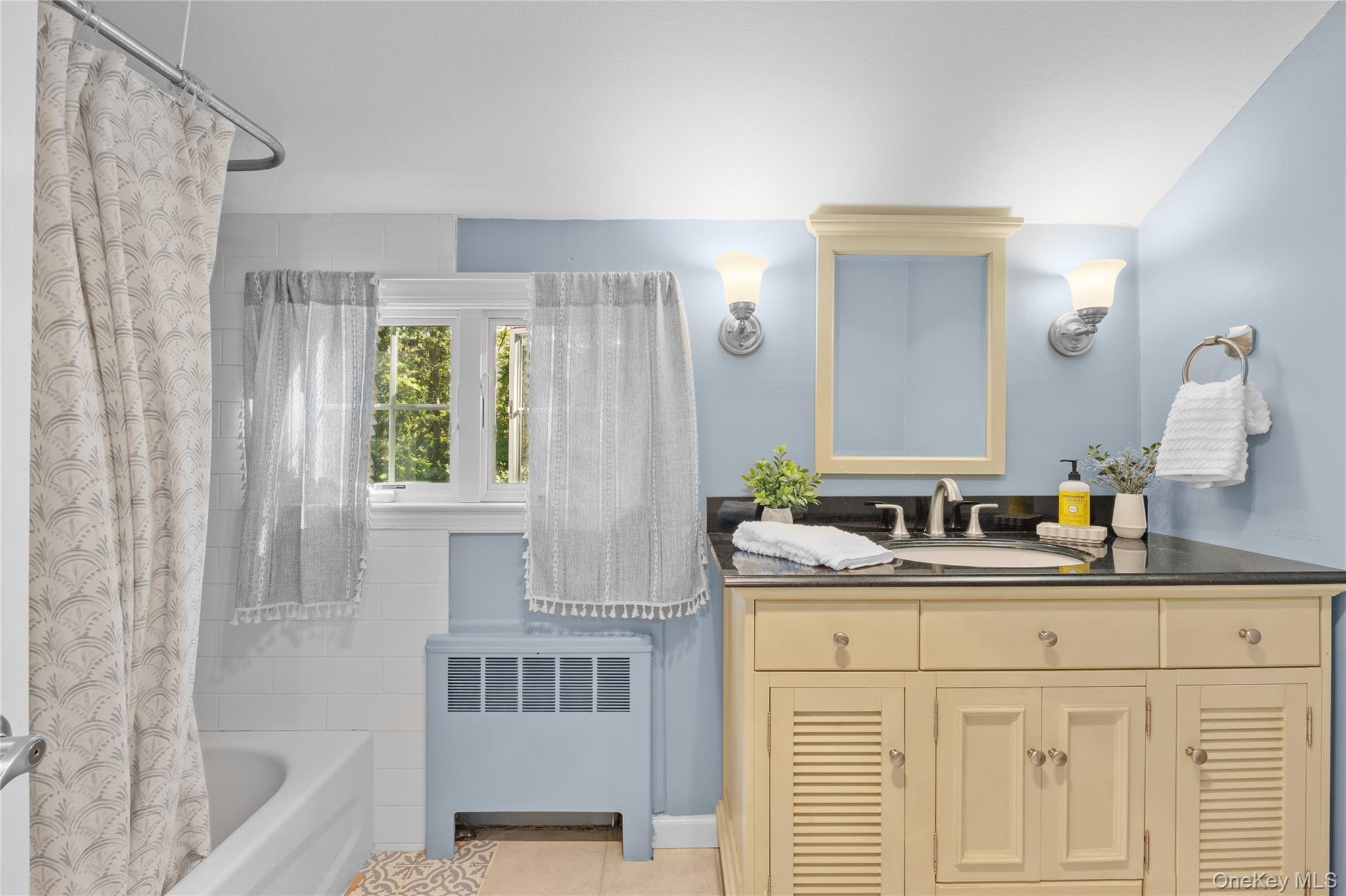 7 Shaker Hollow Road Setauket, NY 11733 - Photo 23 of 38 a bathroom with a tub sink and mirror
