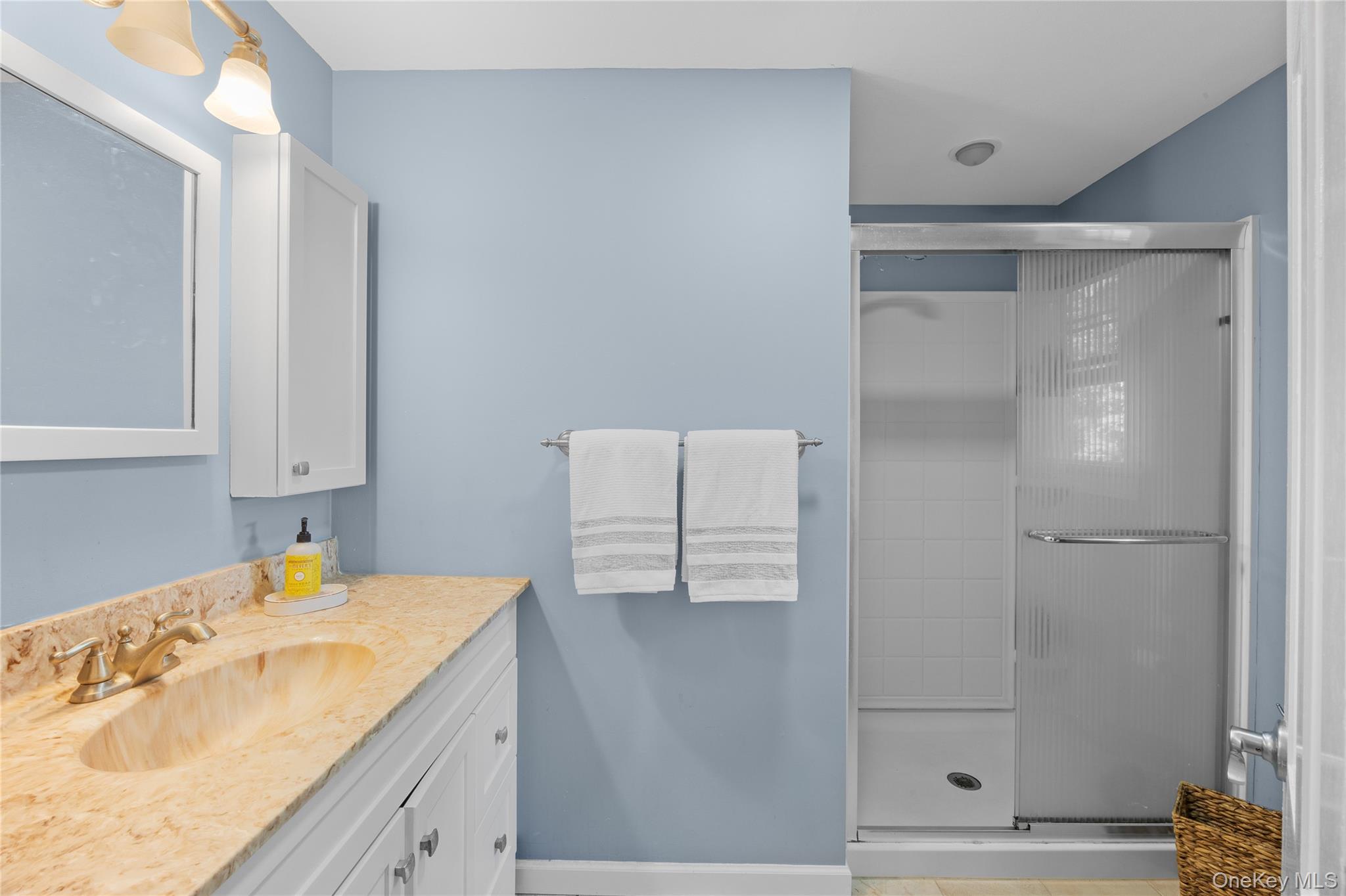 7 Shaker Hollow Road Setauket, NY 11733 - Photo 26 of 38 a bathroom with a sink and a mirror