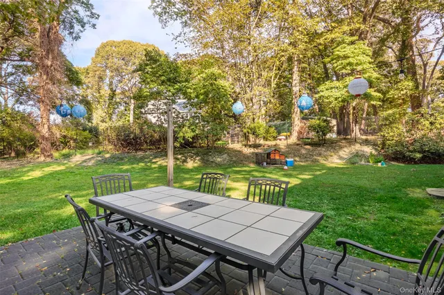 a view of a patio with table and chairs with wooden fence