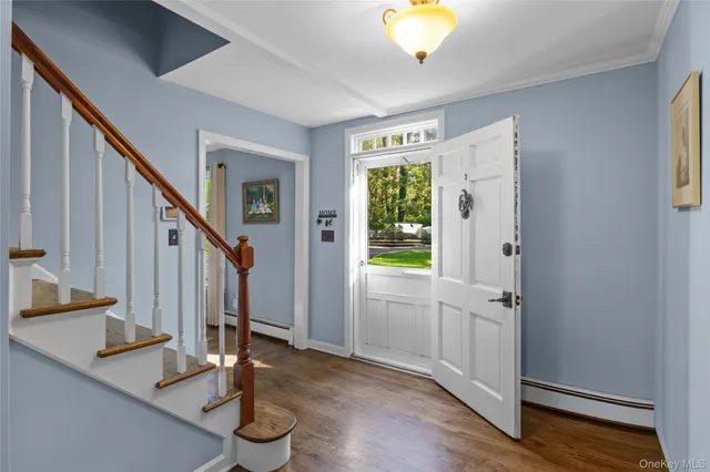 a view of entryway with wooden floor and stairs
