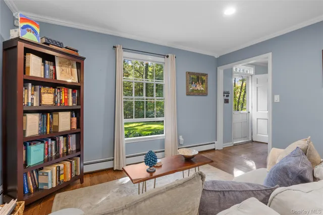 a living room with furniture and a book shelf