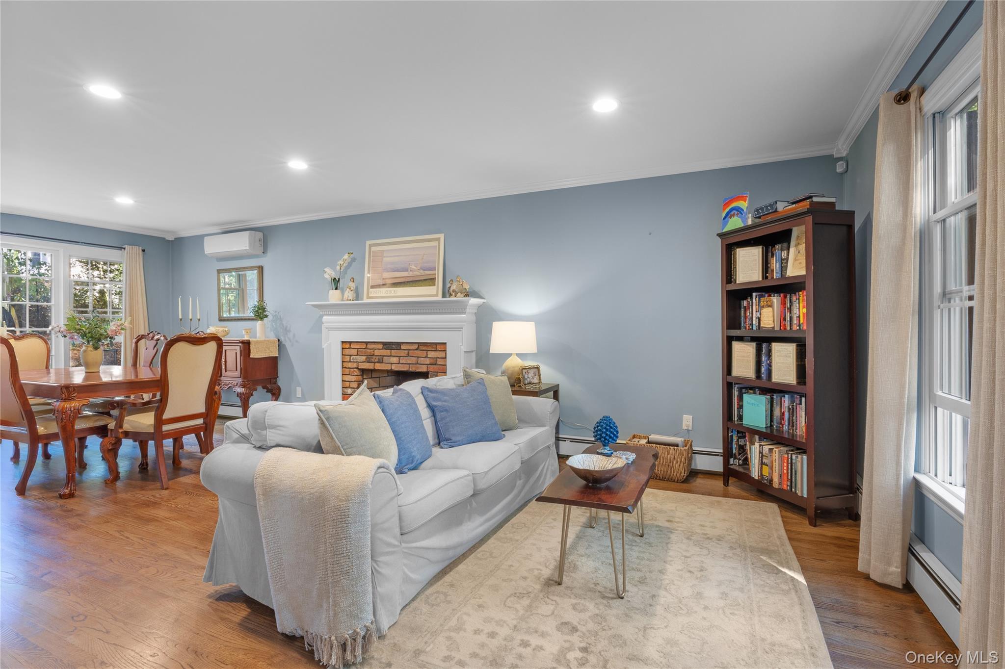 7 Shaker Hollow Road Setauket, NY 11733 - Photo 7 of 38 a living room with furniture a rug and a fireplace