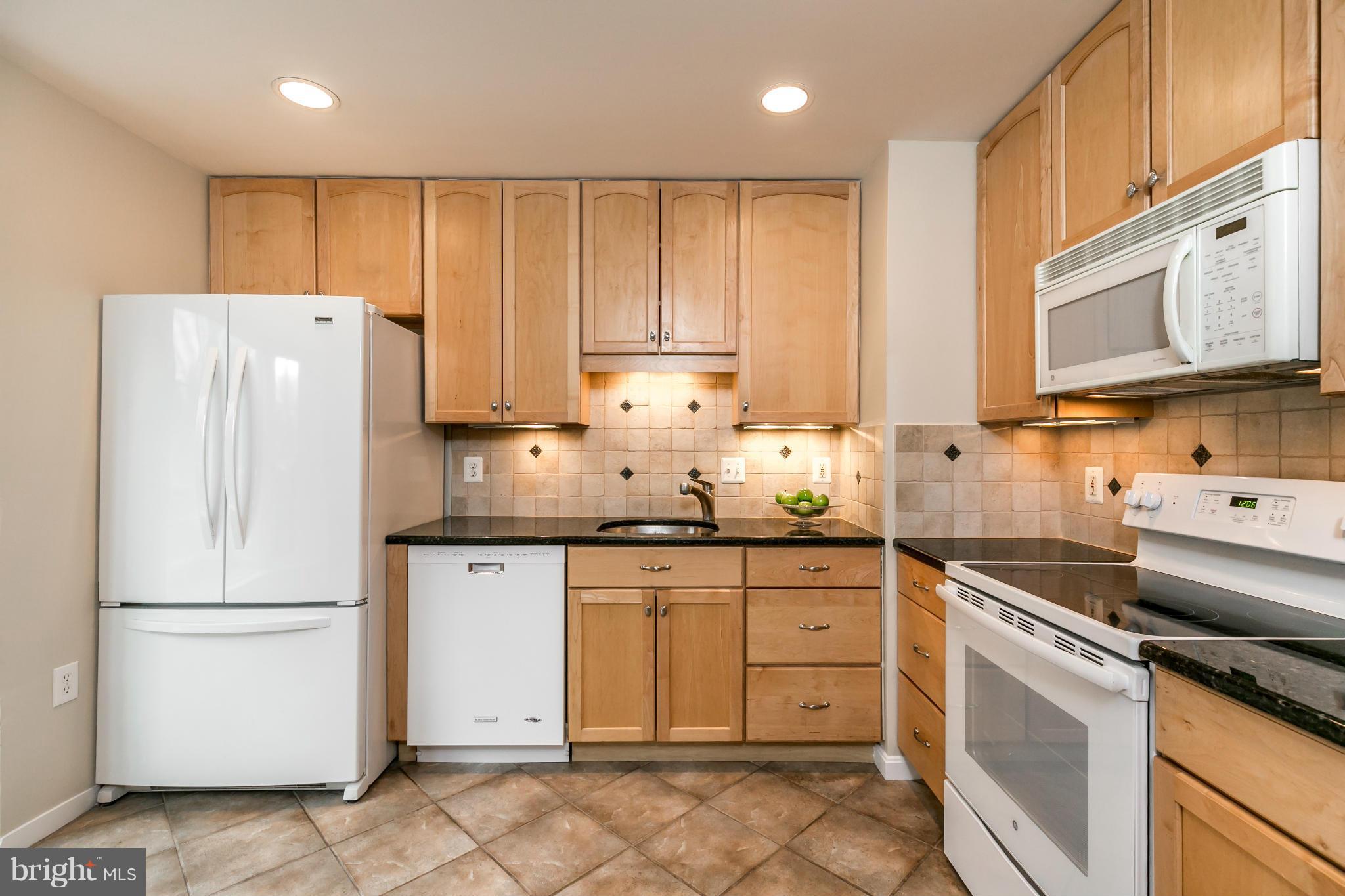 11974 Sentinel Point Court Reston, VA 20191 - Photo 4 of 26 a kitchen with granite countertop cabinets stainless steel appliances and a sink