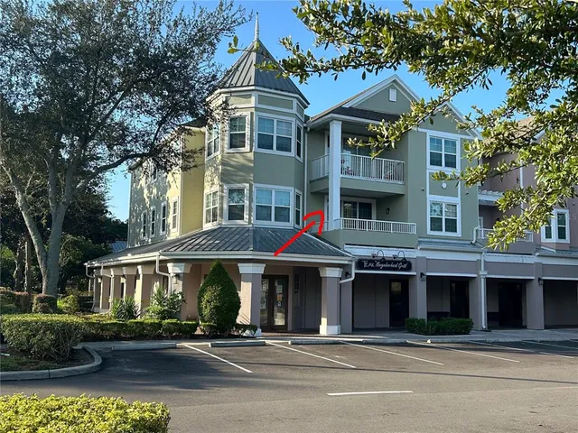a front view of a residential apartment building with a yard