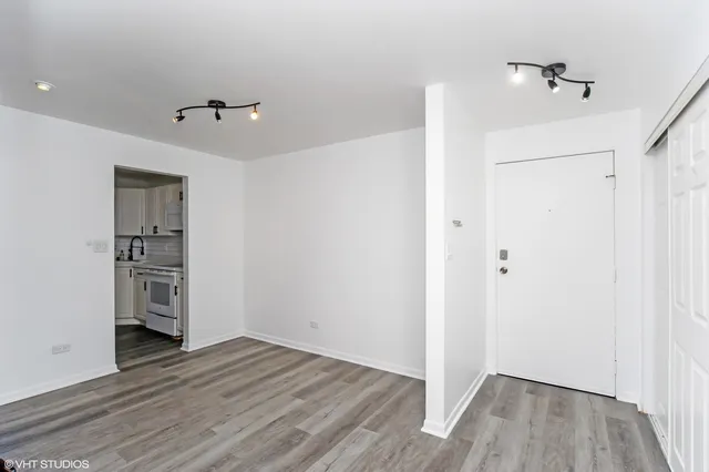 a view of empty room with wooden floor